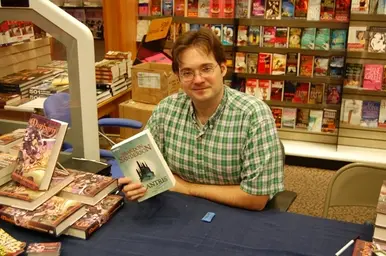 Brandon_Sanderson_with_a_German_copy_of_Elantris.webp