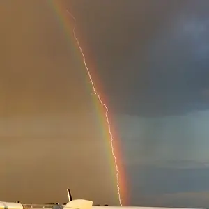 Amazing photo shows lightning striking an airliner flying in a rainbow - Boeing777-D-AALB