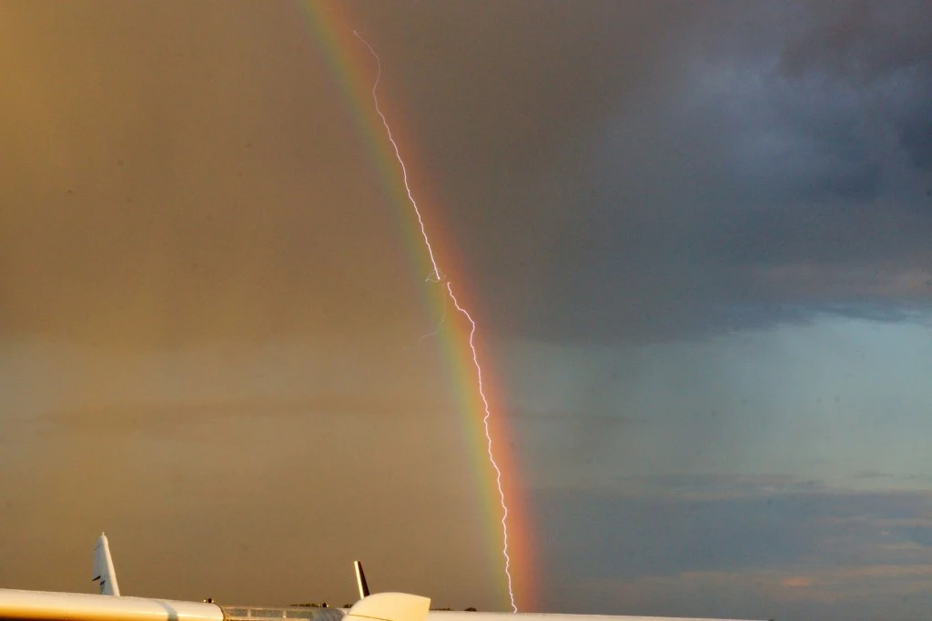 Amazing photo shows lightning striking an airliner flying in a rainbow - Boeing777-D-AALB